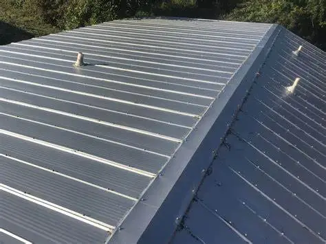 Aerial view of a 5V crimp metal roof with vent pipes, showcasing its distinct panel design and durability for weather resistance