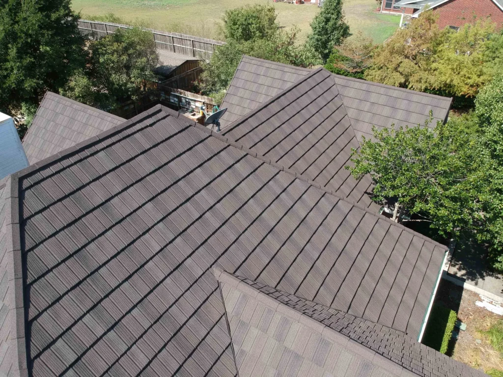 Aerial view of a house with a metal shake roof, highlighting its textured design and durability for residential use
